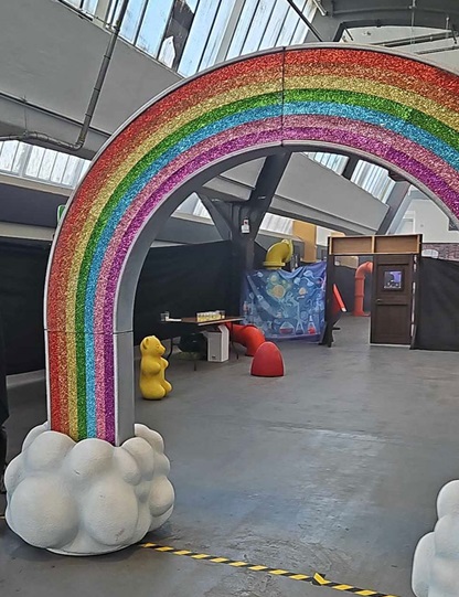 image: a warehouse space decorated sparsely with a small amount of candy-themed props